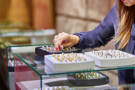 Jeweler helping client to choose a wedding ringの写真素材