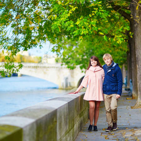 Young dating couple in Paris near the Seine on a nice spring dayの写真素材