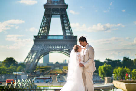 Beautiful just married couple in Paris near the Eiffel towerの写真素材