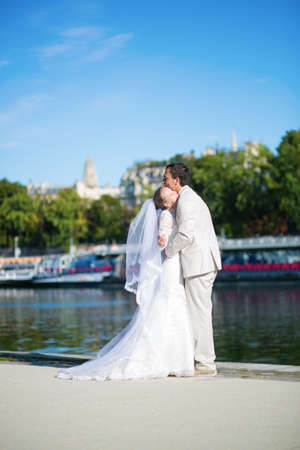 Beautiful just married couple on the Seine embankment in Parisの写真素材