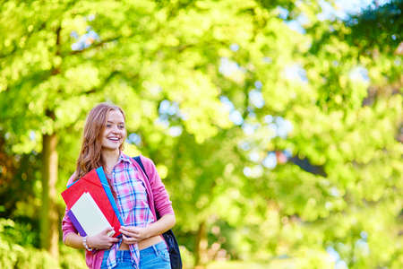 Student girl outdoors going back to school and smilingの写真素材