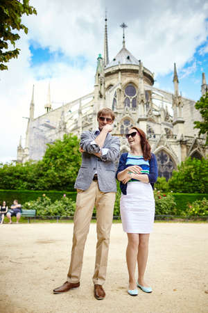 Young couple having fun near Notre-Dame cathedral in Parisの写真素材