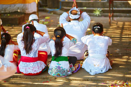 Balinese women praying in a temple during ceremonyの写真素材