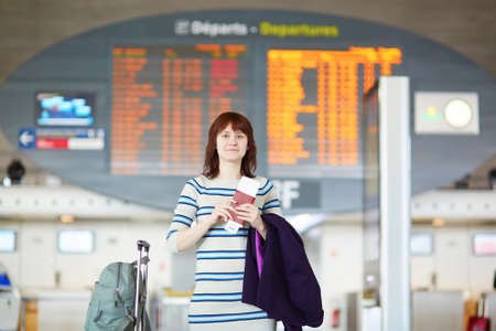 Beautiful young female passenger at the airportの写真素材