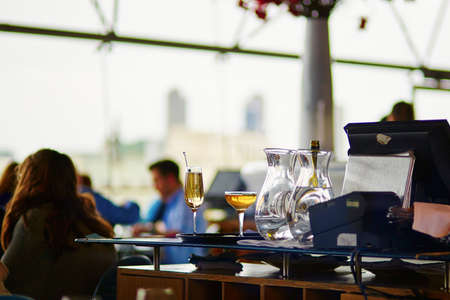 Cocktails and water jugs in restaurant to be picked by a waiter