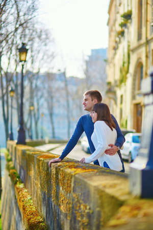 Couple is walking by the Seine embankment in Parisの写真素材