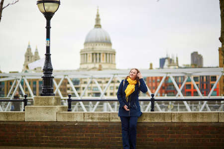 Tourist in London on the Thames embankment with St. Paul's cathedral in the backgroundの写真素材