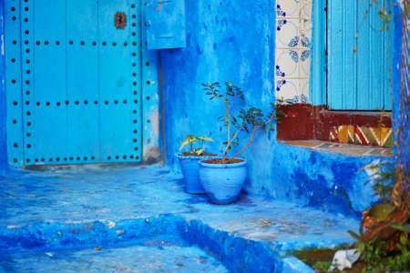 Flower pots on a street in Medina of Chefchaouen, Morocco, small town in northwest Morocco known for its blue buildingsの写真素材