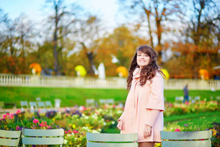 Beautiful young woman on a bright fall day walking in Paris in the Luxembourg gardensの写真素材
