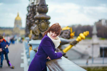 Beautiful young tourist in Paris on the Pont Alexandre IIIの写真素材