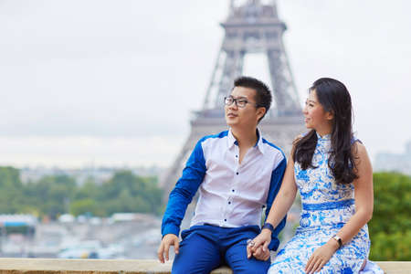 Young romantic Asian couple on Trocadero view point near the Eiffel tower in Paris, Franceの写真素材