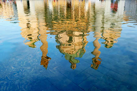 Reflection of St. Charles's Church (Karlskirche) in Vienna, Austria in blue waterの写真素材