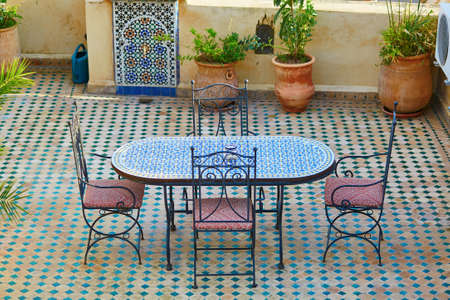 Beautiful and cozy Moroccan restaurant with table decorated with mosaics in Fes, Moroccoの写真素材