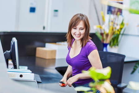 Business, communication and call center concept - beautiful young receptionist at workの写真素材