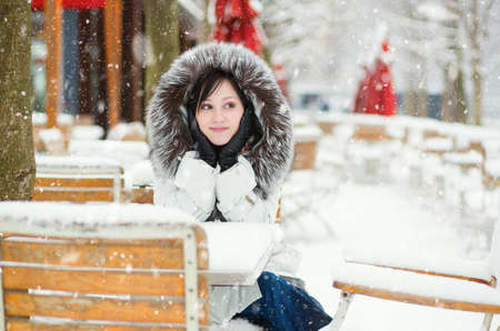 Girl in an outdoor cafe on a winter dayの写真素材
