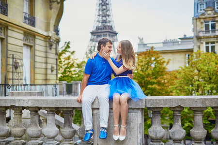 Beautiful young dating couple in Paris near the Eiffel towerの写真素材