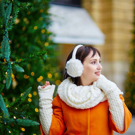 Cheerful young girl in Paris enjoying Christmas timeの写真素材