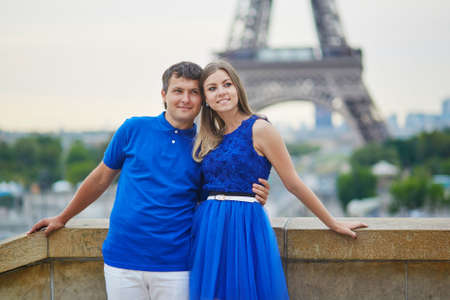 Romantic dating couple on Trocadero viewpoint in Paris, hugging, Eiffel tower is in the background