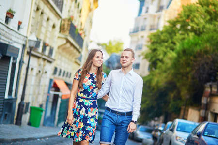 Young romantic couple having a date and walking on a street of Montmartre in Paris, Franceの写真素材