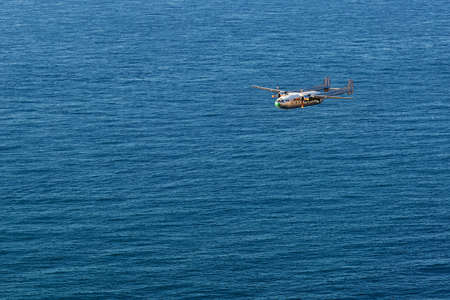 Small plane is flying over the seaの写真素材