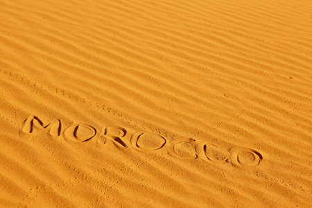 Word Morocco written on the sand in sand dunes in the Sahara Desert, Merzouga, Morocco