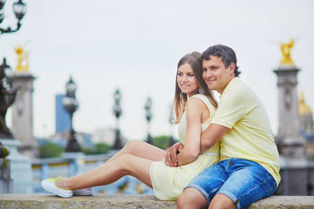 Romantic dating couple of tourist in Paris, on the famous Alexandre III bridge over the Seineの写真素材