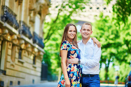 Young romantic couple having on a street near the Eiffel tower in Paris, Franceの写真素材