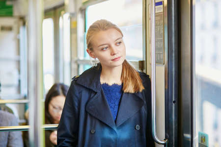 Beautiful young woman travelling in a train of Parisian undergroundの写真素材