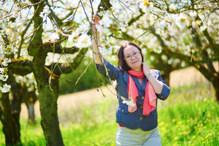 Beautiful middle aged woman in garden on a spring dayの写真素材