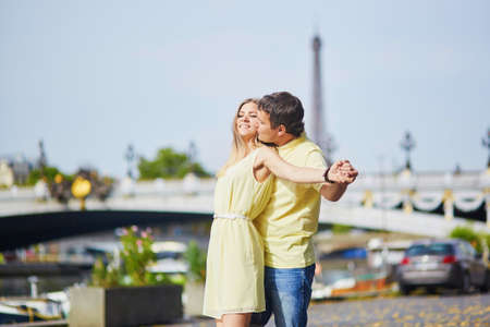 Romantic dating couple of tourist in Paris, near the famous Alexandre III bridge over the Seineの写真素材