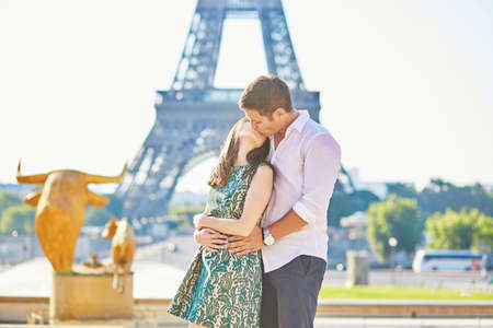 Young romantic couple in Paris near the Eiffel tower, enjoying their vacation to Parisの写真素材