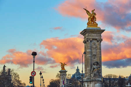 Dramatic sunset over the columns of Pont Alexandre III in Paris, Franceの写真素材