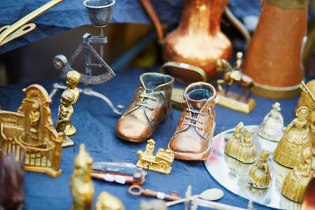 Bronze baby shoes on flea-market in Brugge, Belgiumの写真素材
