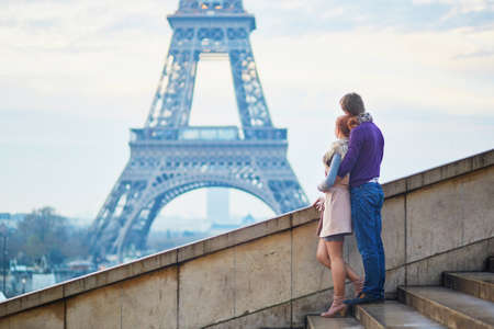 Young romantic couple near the Eiffel tower in Paris, France
