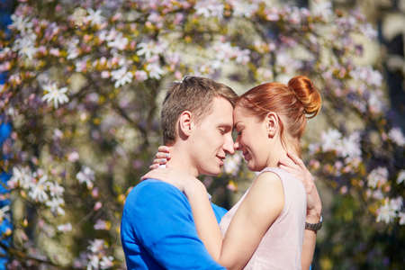 Romantic couple in flowering garden in Paris, Franceの写真素材