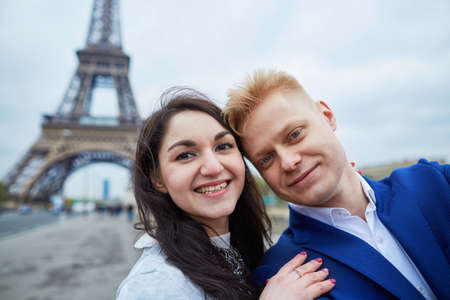 Happy couple making selfie near the Eiffel tower.