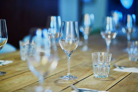 Row of wine glasses on the table in restaurant, bar or et wedding receptionの写真素材
