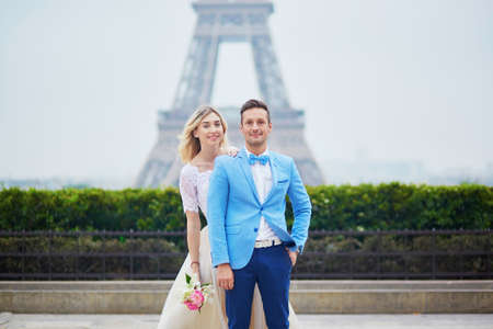 Just married couple near the Eiffel tower on their wedding day. Bride and groom in Paris, Franceの写真素材