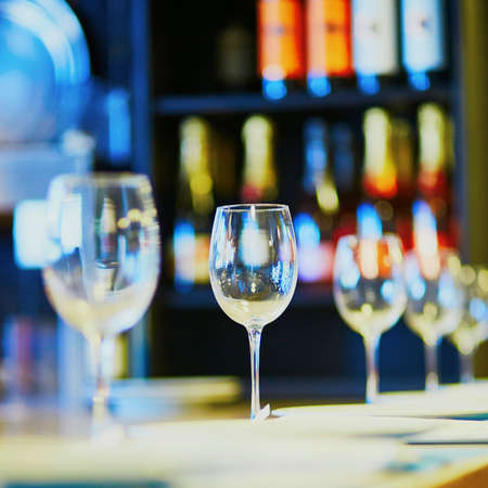 Row of wine glasses on the table in restaurantの写真素材