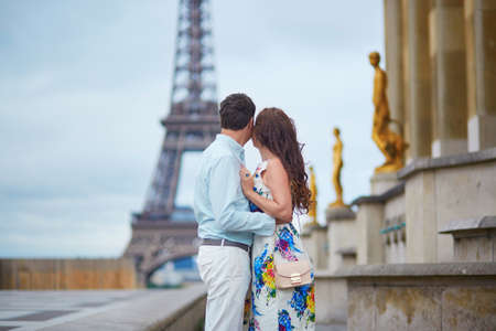 Romantic loving couple having a date near the Eiffel tower. Tourists on vacation or during their honeymoon in Paris, Franceの写真素材