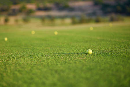 Closeup of several golf balls on the greenの写真素材