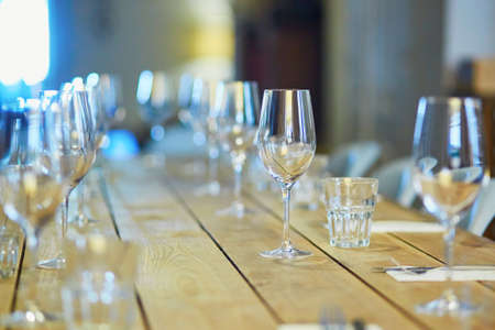 Row of wine glasses on the table in restaurant, bar or et wedding receptionの写真素材