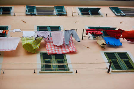Linen hanging on a street of Riomaggiore in Cinque Terre, Liguria, Italyの写真素材