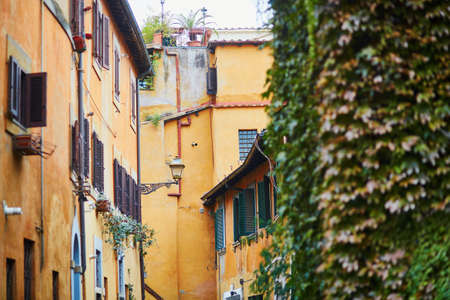 Colorful yellow and orange buildings on a street of Rome, Lazio, Italyの写真素材
