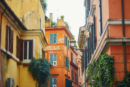 Colorful yellow and orange buildings on a street of Rome, Lazio, Italyの写真素材