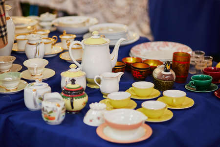 Many porcelain tea cups and pitcher on flea market in Paris, Franceの写真素材