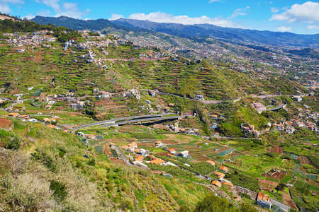Aerial view of typical Madeira landscape with little villages, terrace fields and mountainsの写真素材