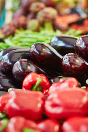 Fresh organic eggplants and bell peppers on farmers market in Paris, Franceの写真素材