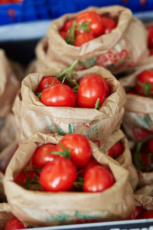 Large heap of fresh ripe organic tomatoes on farmer market in Paris, Franceの写真素材