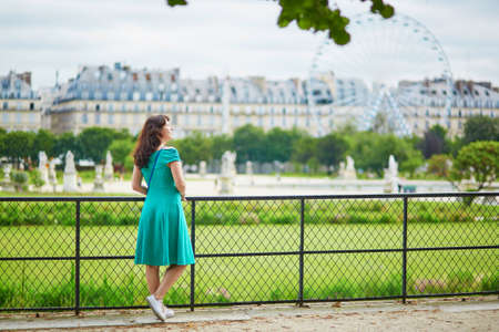 Beautiful young woman relaxing in Parisian Tuileries park on a summer dayの写真素材